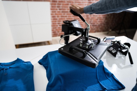 pretty-female-tailor-sits-table-with-sewing-machine-sews-fabric.jpg